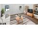 Stylish living room features new floors, white sofa, rug, and updated decor at 38832 Henry Dr, Zephyrhills, FL 33542