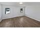 Bright living room features new hard floors, fresh white paint, and updated baseboards at 38832 Henry Dr, Zephyrhills, FL 33542