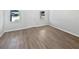 Bright living room features new hard floors, fresh white paint, and updated baseboards at 38832 Henry Dr, Zephyrhills, FL 33542