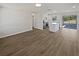 Open-concept living space features new floors and transitions to the kitchen at 38832 Henry Dr, Zephyrhills, FL 33542
