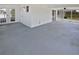 Large sunroom features concrete flooring, white walls, and access to the backyard at 38832 Henry Dr, Zephyrhills, FL 33542