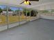 Enclosed sunroom with screened windows, concrete flooring, and a ceiling fan at 38832 Henry Dr, Zephyrhills, FL 33542