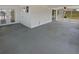 Spacious sunroom with concrete flooring, white walls, and access to the backyard at 38832 Henry Dr, Zephyrhills, FL 33542