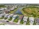 Aerial community view showcases picturesque homes, a tranquil lake, and expansive green spaces at 16231 Pine Mist Dr, Bradenton, FL 34211