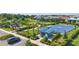 Aerial view of community park with basketball court, playground, mailboxes, and lush landscaping near residential homes at 16231 Pine Mist Dr, Bradenton, FL 34211