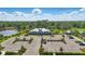 Aerial view of community clubhouse, surrounded by parking, landscaping, and a lake at 16231 Pine Mist Dr, Bradenton, FL 34211