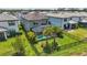 Aerial view of a backyard with a screened pool, black fence, and lush landscaping, offering privacy and relaxation at 16231 Pine Mist Dr, Bradenton, FL 34211