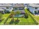 Spacious backyard with screened-in pool, lush landscaping, and black metal fence at 16231 Pine Mist Dr, Bradenton, FL 34211