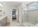 Modern bathroom showcasing a glass-enclosed shower with tile surround and bathroom vanity at 16231 Pine Mist Dr, Bradenton, FL 34211