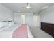 Bright bedroom features a ceiling fan, neutral walls, and doorway to walk-in closet at 16231 Pine Mist Dr, Bradenton, FL 34211