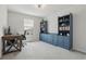 Bright bedroom features a ceiling fan, desk, and custom blue built-in bookshelves and cabinets at 16231 Pine Mist Dr, Bradenton, FL 34211