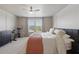 Bedroom featuring a large bed, fitness bike, and natural light streaming through the window at 16231 Pine Mist Dr, Bradenton, FL 34211