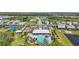 Aerial view of a community pool with parking, playground, and luxurious landscaping at 16231 Pine Mist Dr, Bradenton, FL 34211