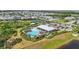 Aerial view of community pool and play area in a neighborhood with scenic ponds at 16231 Pine Mist Dr, Bradenton, FL 34211