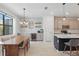 Open-concept dining area with a wooden table, stylish seating, and a bar area, perfect for entertaining guests at 16231 Pine Mist Dr, Bradenton, FL 34211