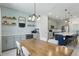 Open-concept dining room and kitchen area with decor shelves, beverage center, and seating for guests at 16231 Pine Mist Dr, Bradenton, FL 34211