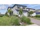 Charming two-story home with a well-maintained lawn and landscaping, featuring a brick driveway and a two-car garage at 16231 Pine Mist Dr, Bradenton, FL 34211