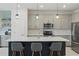 Modern kitchen featuring gray cabinetry, a central island with seating, stainless steel appliances, and stylish pendant lighting at 16231 Pine Mist Dr, Bradenton, FL 34211