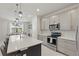 Well-appointed kitchen with an island, stainless steel appliances, gray cabinets, and tile flooring, providing a contemporary cooking space at 16231 Pine Mist Dr, Bradenton, FL 34211
