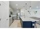 Modern kitchen featuring gray cabinets, stainless steel appliances, and a large center island with pendant lighting at 16231 Pine Mist Dr, Bradenton, FL 34211