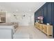 Bright and open living space with tile floors, a blue accent wall, contemporary decor, and lots of natural light at 16231 Pine Mist Dr, Bradenton, FL 34211