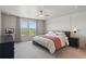 Main bedroom featuring neutral colors, a ceiling fan, bright lighting, and large windows at 16231 Pine Mist Dr, Bradenton, FL 34211