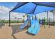 Community playground featuring a shaded play area with slides, climbing structures, and swings for outdoor fun at 16231 Pine Mist Dr, Bradenton, FL 34211