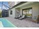 Relaxing screened-in pool area with a spa, lounge chairs, and outdoor TV for entertainment at 16231 Pine Mist Dr, Bradenton, FL 34211