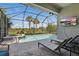 Beautiful pool and patio inside screened enclosure, with outdoor tv and lounge seating at 16231 Pine Mist Dr, Bradenton, FL 34211
