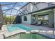 Relaxing screened-in pool area with a spa, lounge chairs, and outdoor TV for entertainment at 16231 Pine Mist Dr, Bradenton, FL 34211