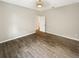Bedroom displaying wooden flooring, recessed lighting, and open doorway at 19664 Ship Wheel Way, Land O Lakes, FL 34638