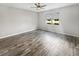 A spacious bedroom with a ceiling fan and wood-look flooring, offering a serene and comfortable atmosphere at 19664 Ship Wheel Way, Land O Lakes, FL 34638