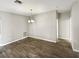 Empty dining room featuring modern flooring and a contemporary light fixture at 19664 Ship Wheel Way, Land O Lakes, FL 34638