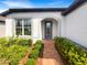 Charming home exterior with a well-manicured lawn, beautiful landscaping, and a welcoming entrance at 19664 Ship Wheel Way, Land O Lakes, FL 34638