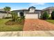 Charming single-story home with well-manicured landscaping and a brick paved driveway at 19664 Ship Wheel Way, Land O Lakes, FL 34638