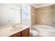 Bathroom featuring tile flooring, a bathtub with tile surround, and a vanity with counter space at 3319 Thistledown Ln, Land O Lakes, FL 34638