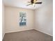 This cozy bedroom features neutral walls, carpeted floors, and a ceiling fan for added comfort at 3319 Thistledown Ln, Land O Lakes, FL 34638