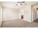 Spacious bedroom with neutral carpet, access to the ensuite bathroom and plenty of natural light at 3319 Thistledown Ln, Land O Lakes, FL 34638