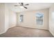 Comfortable bedroom with neutral carpet, two windows, and plenty of space for furnishings at 3319 Thistledown Ln, Land O Lakes, FL 34638