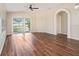 Bright living room with hardwood floors, neutral walls, and plenty of natural light at 3319 Thistledown Ln, Land O Lakes, FL 34638