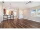 View of the living room featuring hardwood floors, neutral paint, and easy access to other parts of the house at 3319 Thistledown Ln, Land O Lakes, FL 34638