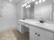 Bathroom featuring double sinks, a walk-in shower, and tiled floors at 6370 Sturbridge Ct, Sarasota, FL 34238
