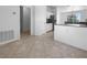 Bright kitchen area with pantry, breakfast bar, and stainless refrigerator at 6370 Sturbridge Ct, Sarasota, FL 34238
