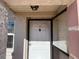 Exterior front door with sidelight, peephole, door knocker, and light fixture at 10709 Dowry Ave, Tampa, FL 33615