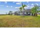Large backyard with landscaping featuring covered patio with outdoor furniture at 31840 Magna Gulf Loop, San Antonio, FL 33576