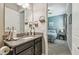 Bathroom featuring a granite-topped vanity, and is adjacent to the primary bedroom at 31840 Magna Gulf Loop, San Antonio, FL 33576