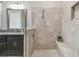 Bathroom featuring tiled shower with glass surround and built-in bench and dual sinks at 31840 Magna Gulf Loop, San Antonio, FL 33576