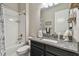 Bathroom featuring tiled shower/tub, granite counter, and vanity, offering a clean and functional space at 31840 Magna Gulf Loop, San Antonio, FL 33576