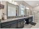 Bathroom with granite counters, dual sinks, makeup vanity and glass enclosed tiled shower at 31840 Magna Gulf Loop, San Antonio, FL 33576