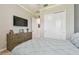 Bedroom with a dresser, television, and closet is a tranquil retreat for relaxation and entertainment at 31840 Magna Gulf Loop, San Antonio, FL 33576